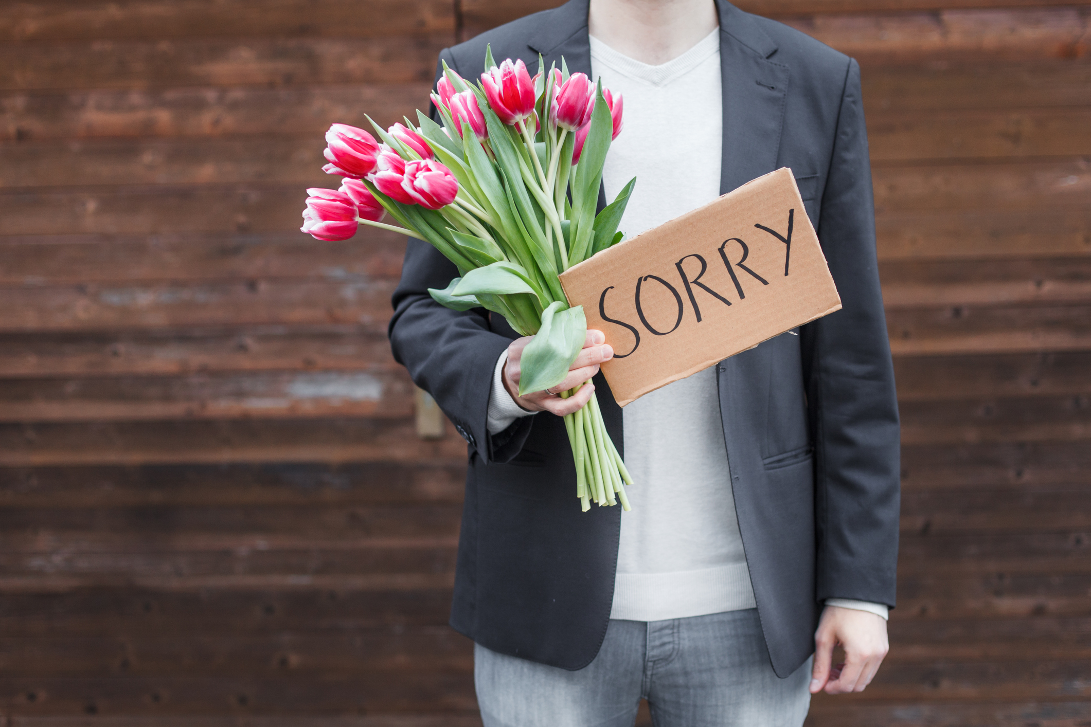 Man apologizing with flowers